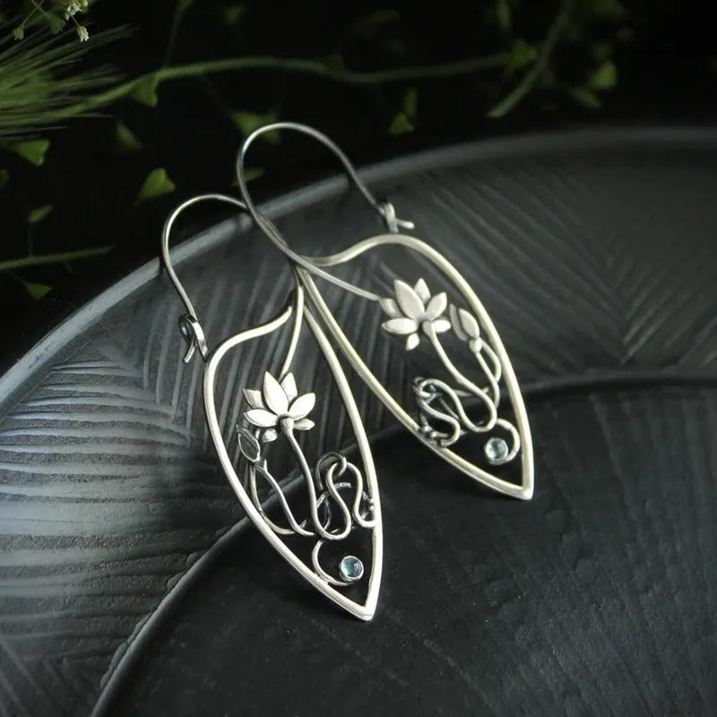 Silver lotus flower earrings with geometric shapes and rhinestone details