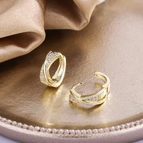 14K yellow geometric copper earrings with zircon accent on white background
