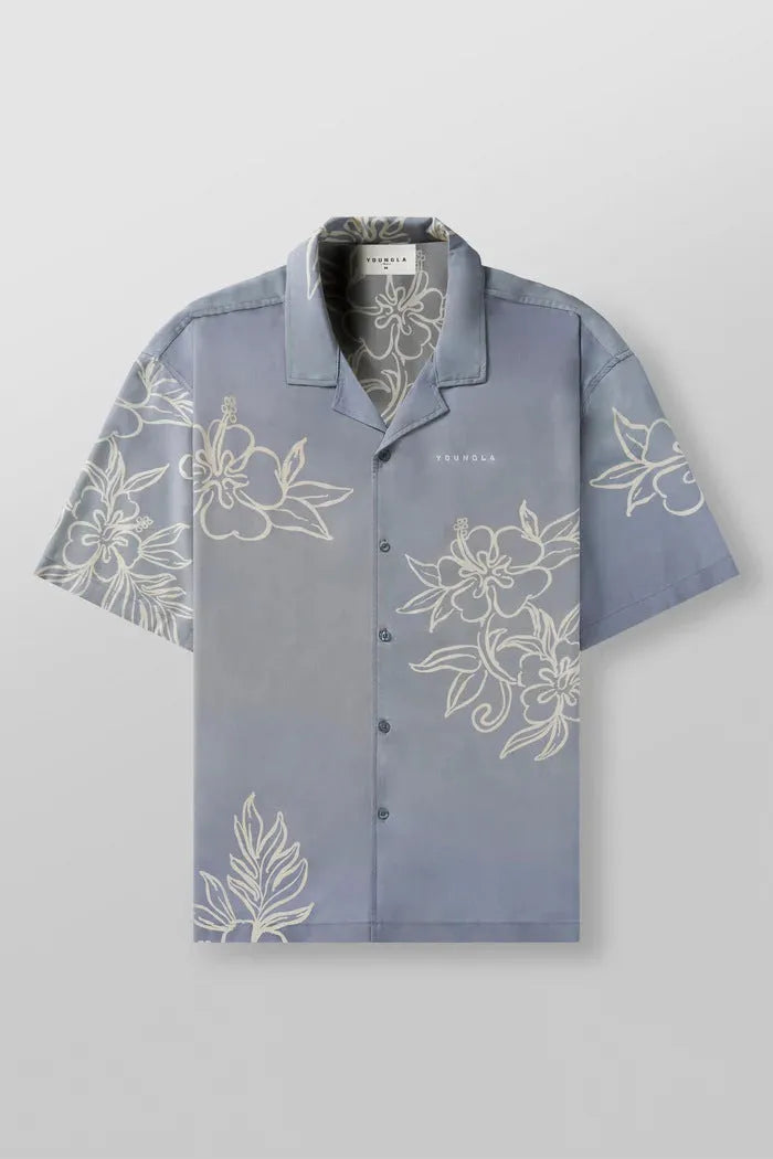 A man's loose-fitting, short-sleeve casual top with a floral print, shown in a light colour.