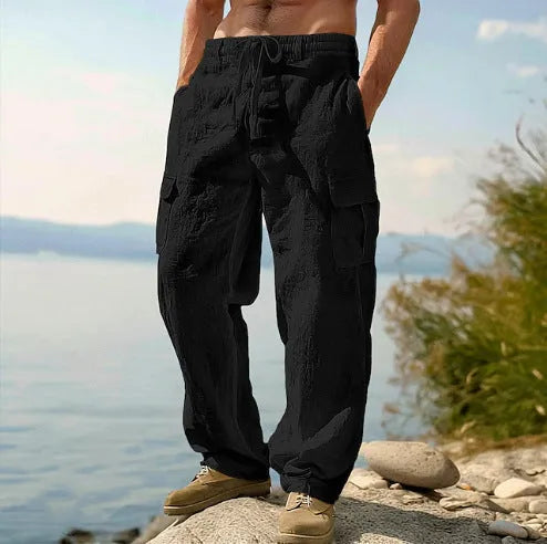 Man wearing loose-fitting, solid-colour cotton wide-leg casual trousers.