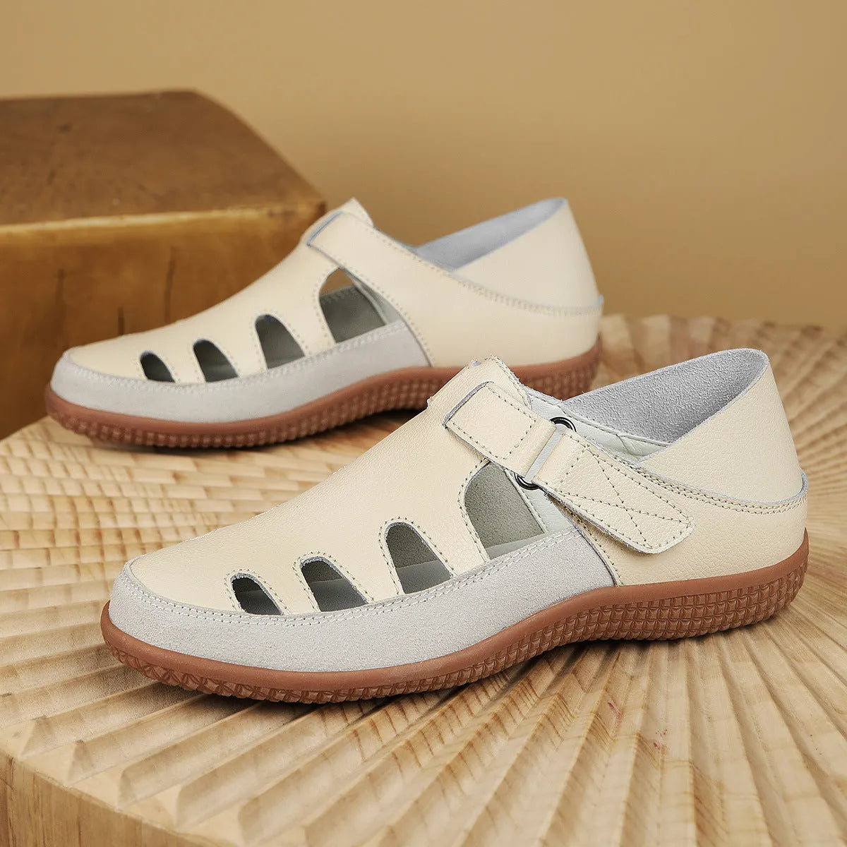 Blue plus size women's flat sandals with hollow-out design and toe cap on a thick rubber sole.
