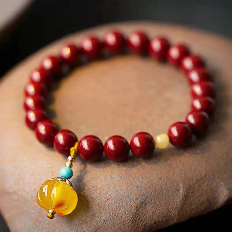 Gold cinnabar bracelet with wave design and copper beads in traditional Chinese style