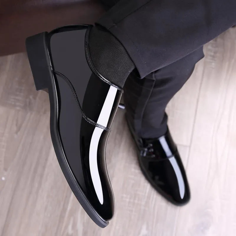 Men's black and brown formal business shoes with round toe and square heel on a rubber sole.