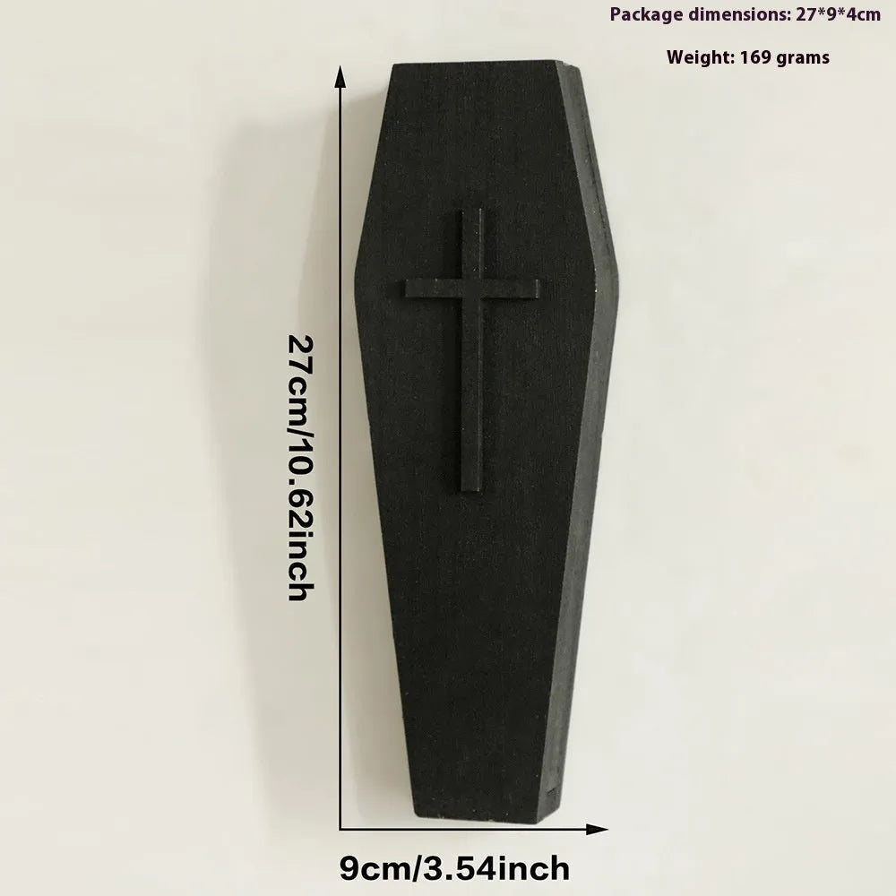 Black wooden cross-shaped wall shelf with a small ledge, measuring 27cm tall.