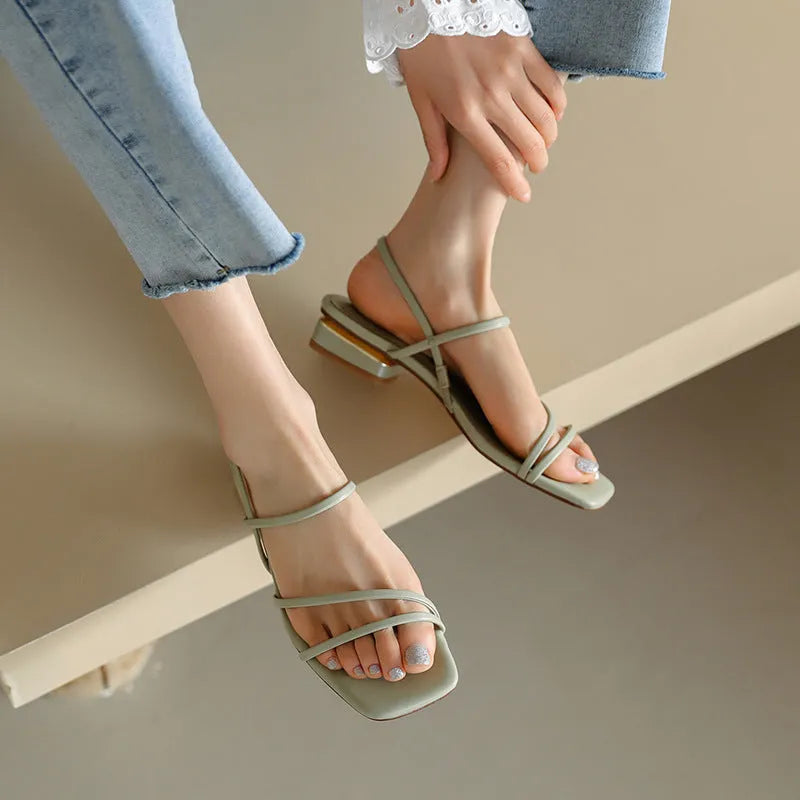 Women's flat green microfiber Roman sandals with square open toe on a white background.