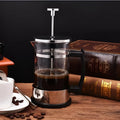 Compact glass and stainless steel cold brew coffee maker with 350ml capacity.