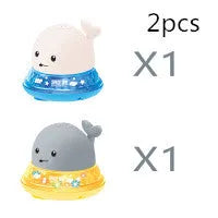 Electric whale-shaped baby bath toy with water spray, LED lights, and automatic water sensor