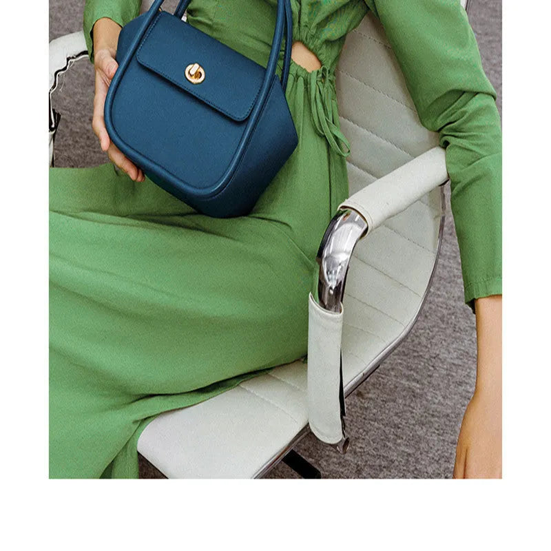 Women's leather wing-shaped tote bag with hard handle and cross-body strap in four colour options