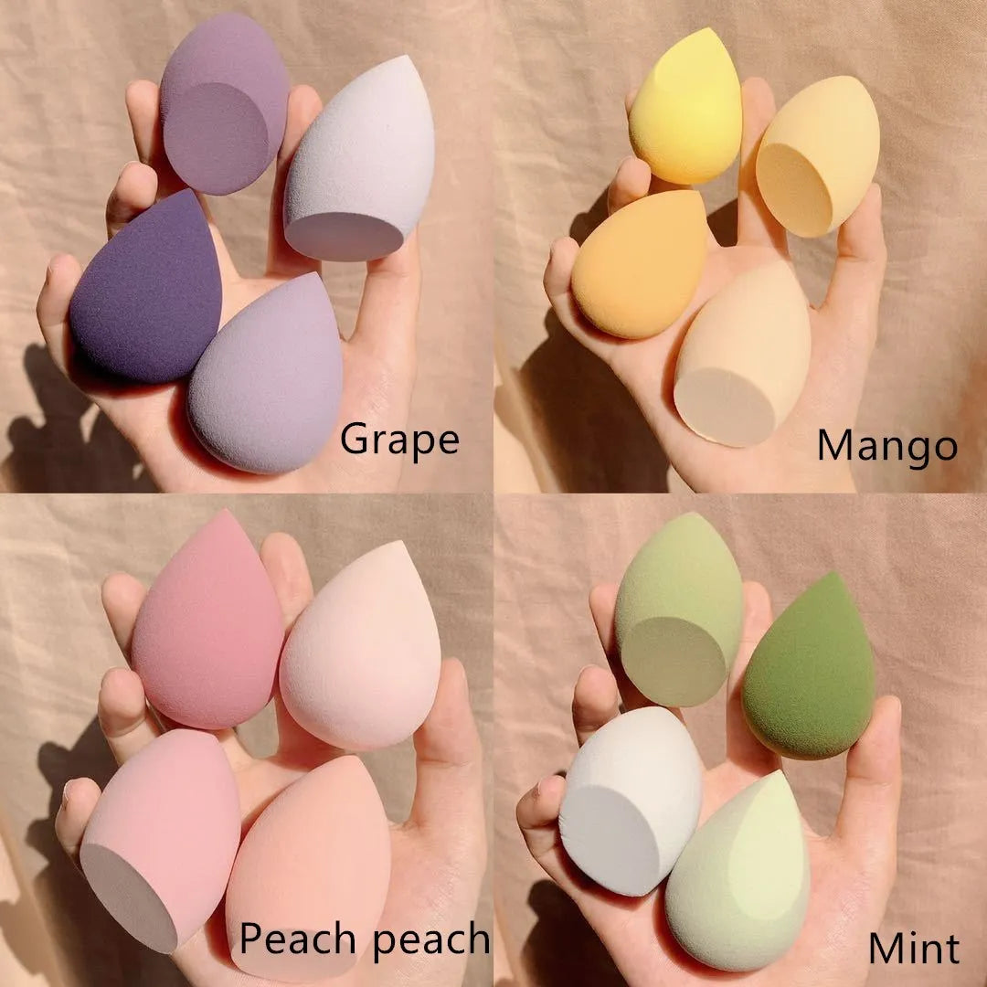 Set of four small 6cm cubic makeup sponge storage cases in grape, mango, mint, and peach colours.