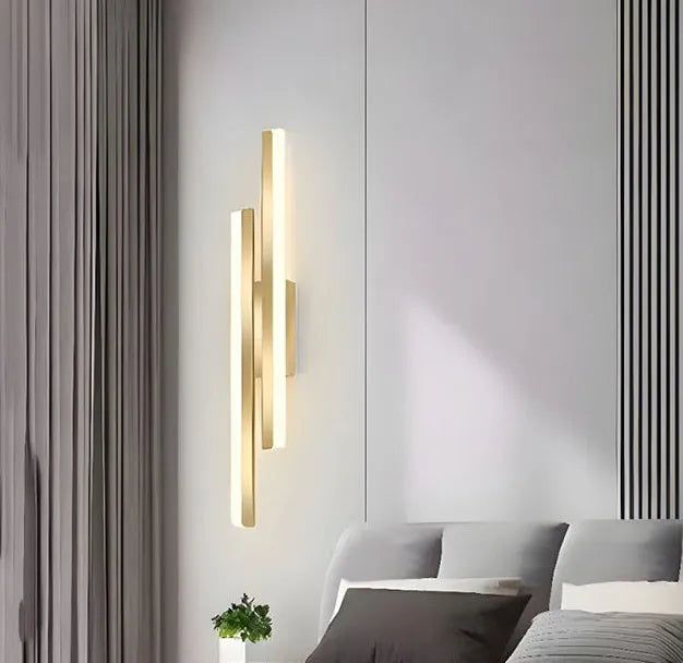Gold-finish 500mm long double line wall lamp with LED light on a modern wall.