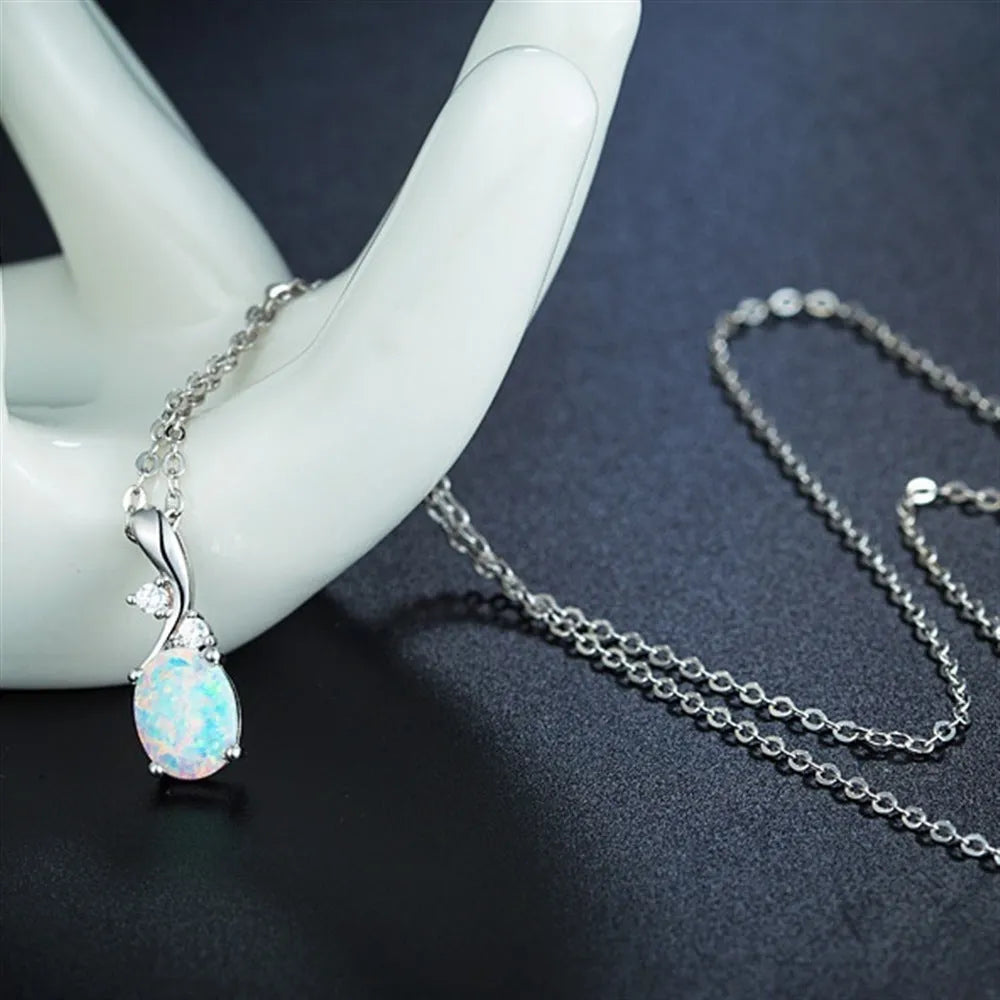 Water drop shaped opal pendant necklace with adjustable O-chain in rose gold or white electroplated finish.
