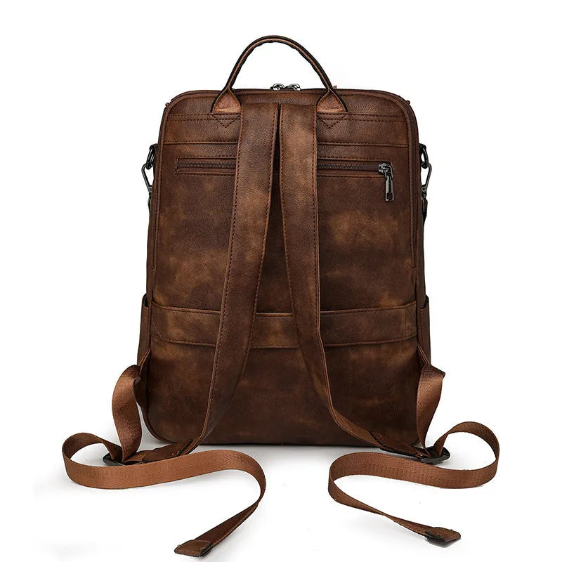 Retro college student backpack in PU leather with curved shoulder straps showing stitching detail