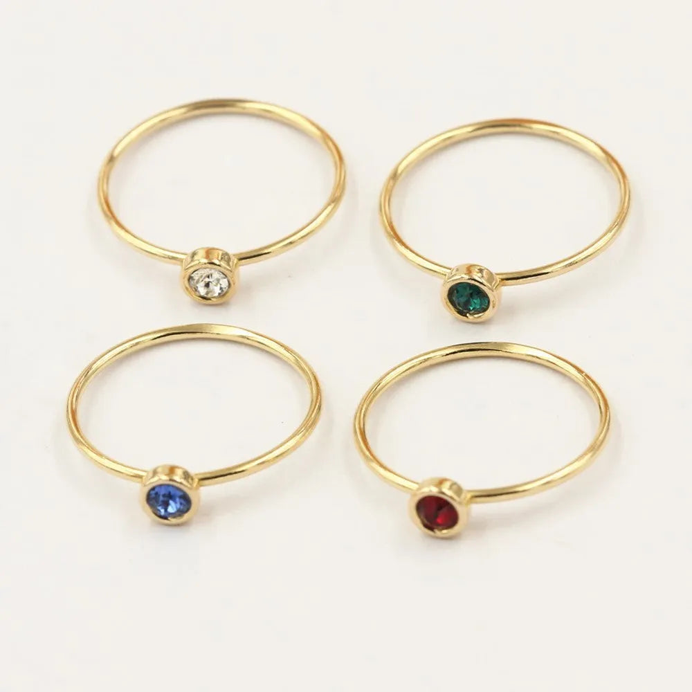 Women's 14K gilded GF zircon knuckle ring shown in green, blue, dark red, and white on a sizing chart.