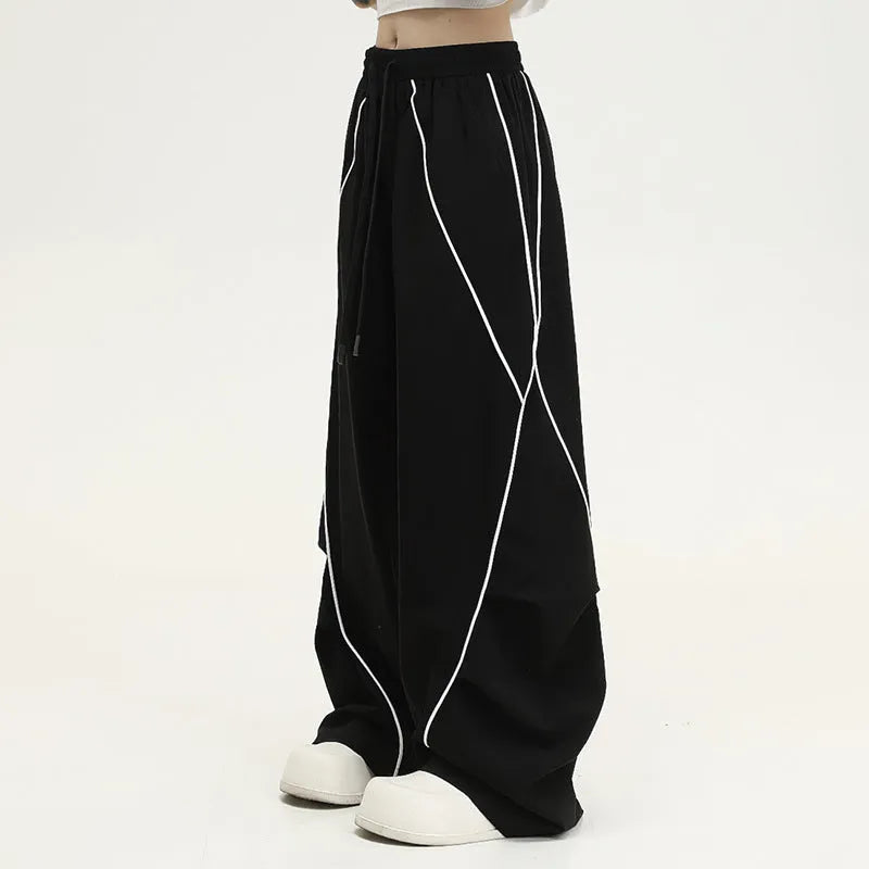 Black pleated hip hop trousers with wide-leg design and stripe pattern