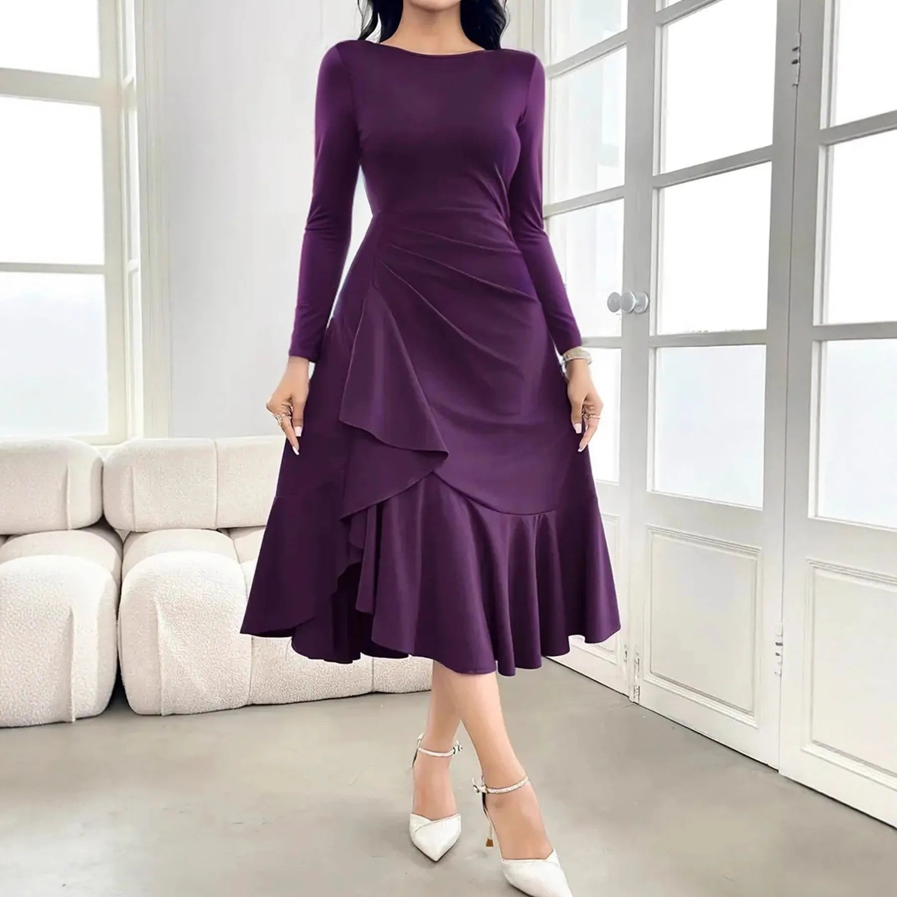 Purple women's long sleeve pullover dress with round neck and ruffle detail on a hanger.