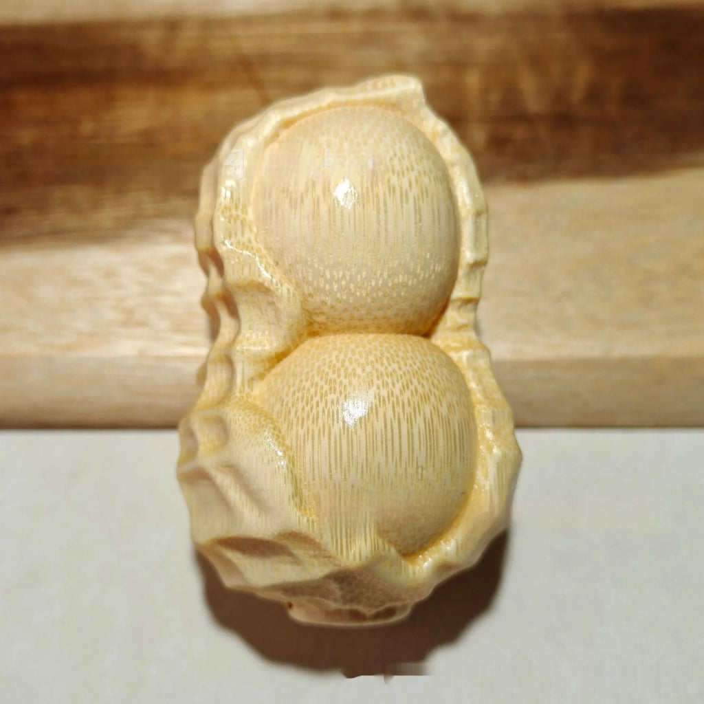 Solid bamboo carving peanut ornament with natural finish and modern simplicity design