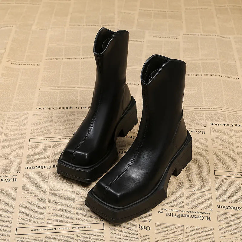 Black and brown platform Martin boots with square toe, high heel, and back zipper closure.