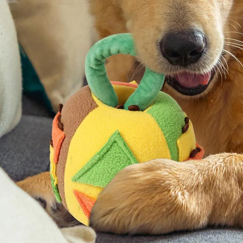 Green or pink polyester plush ball dog toy with treat pockets and a squeaker, shown next to dog treats.