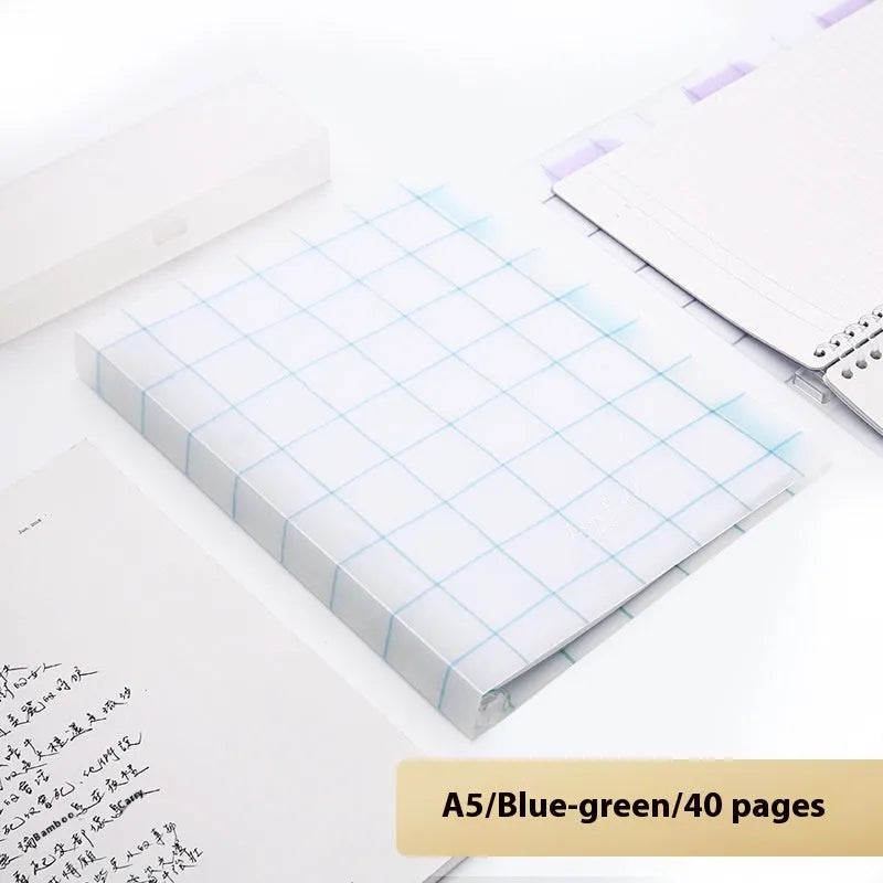 Refillable loose-leaf spiral notebook with PP cover open, showing raw wood pulp paper in grid ruling.