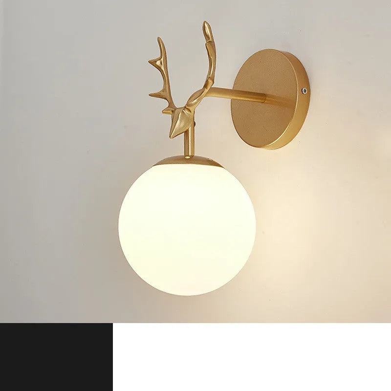 Nordic minimalist round glass wall lamp in golden finish mounted on a wall.