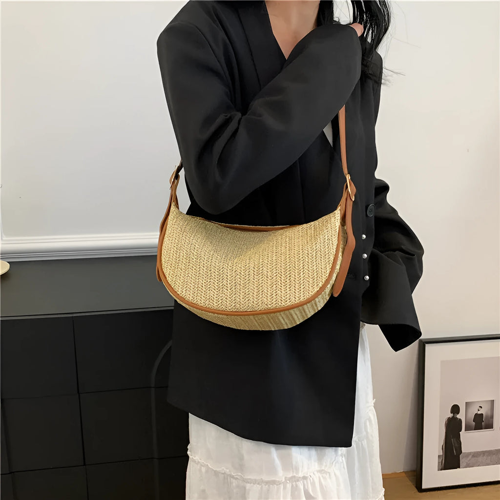Women's woven straw crossbody bag showing internal phone pocket and file compartment