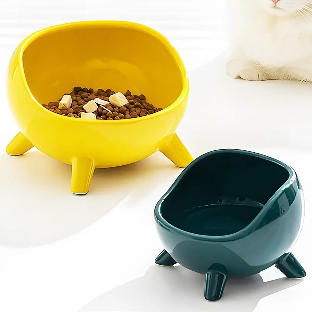 Green ceramic pet food bowl with four-legged base and rounded arc design