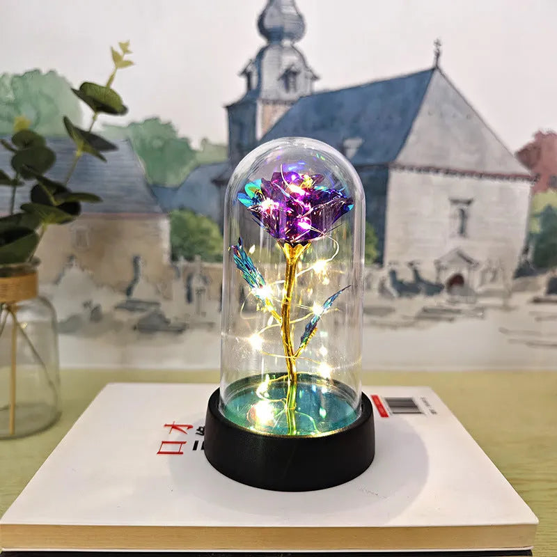 Small plastic night lamp with glass cover and flower decoration on black base