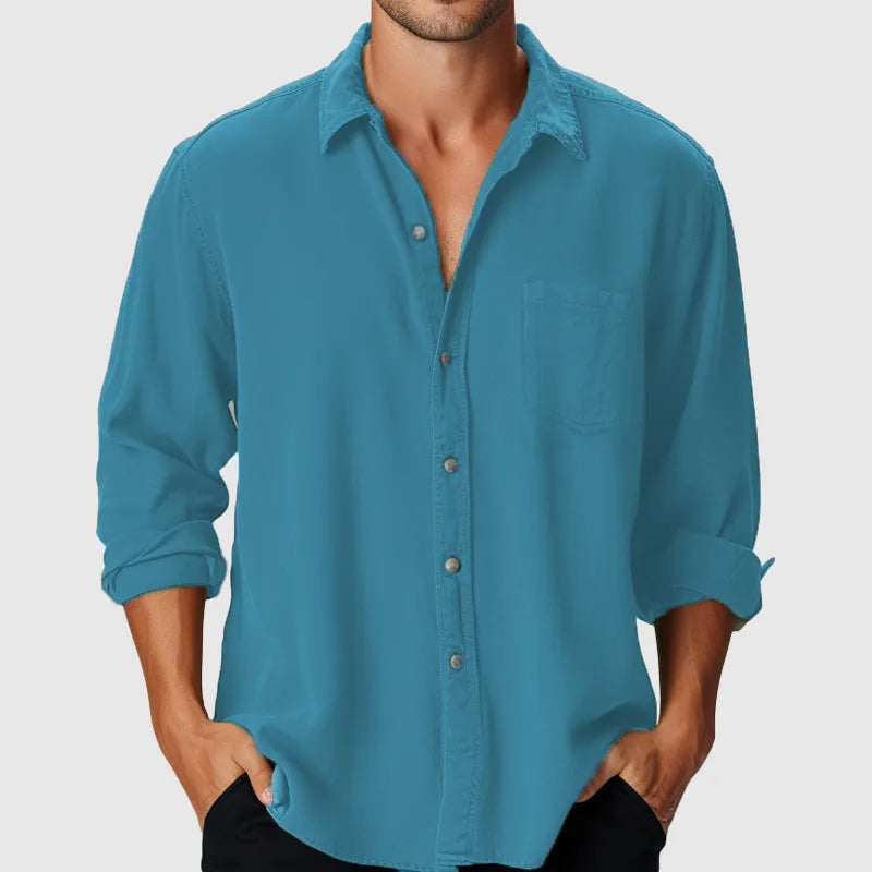 Man wearing a loose-fit long sleeve casual shirt with a stand collar, suitable for beach holidays.