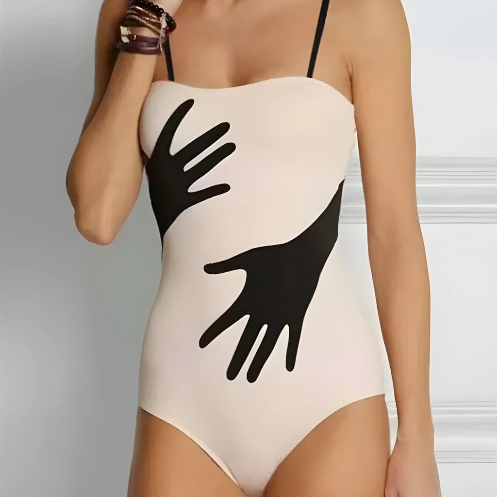 Women's one-piece bikini swimsuit with a light gauze skirt attached, shown on a model.