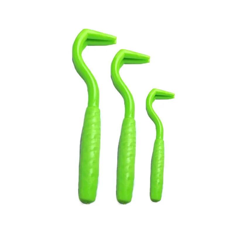 Set of three coloured tick removal hooks for dogs on a white background.