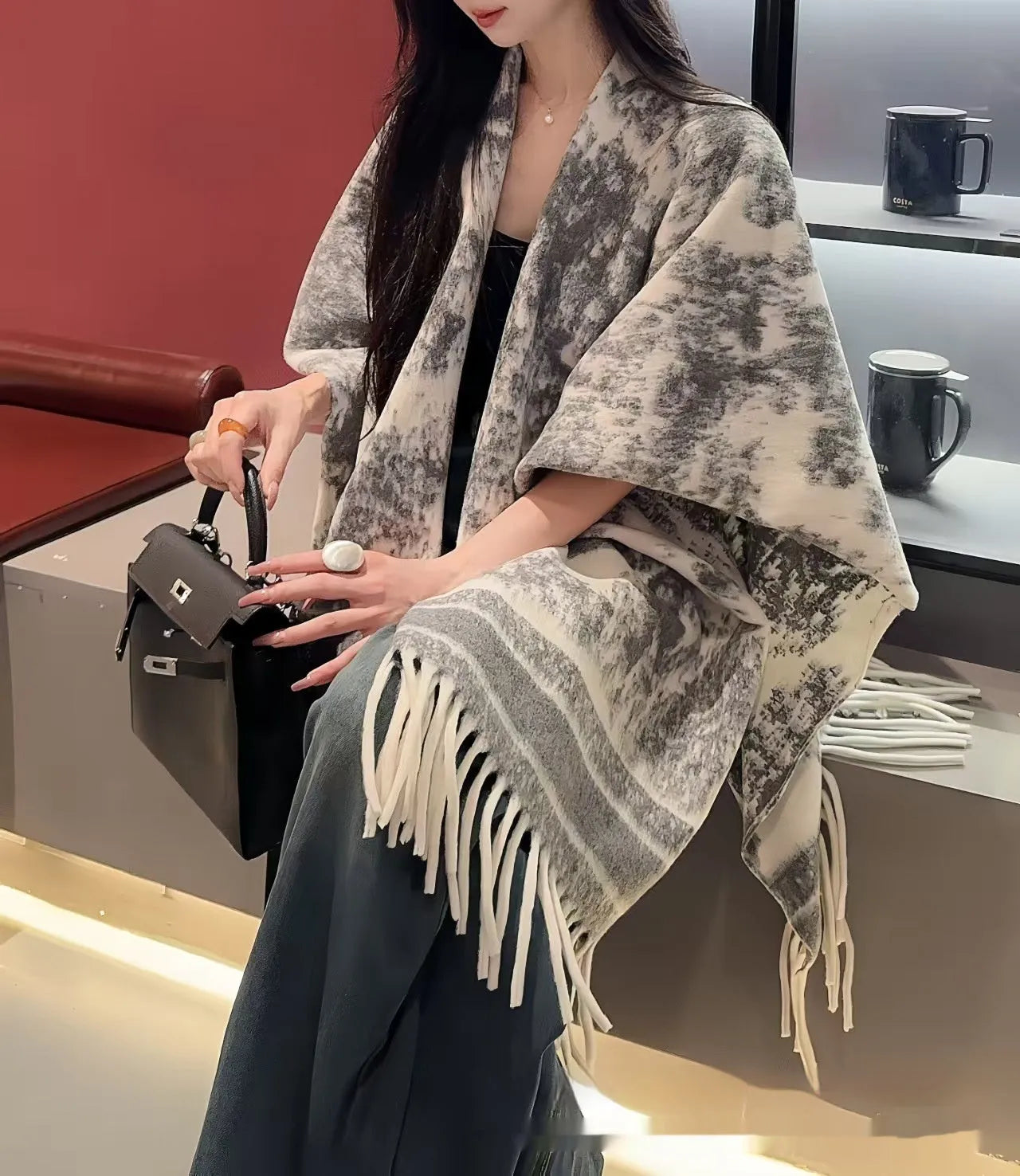 Women's polyester scarf cape with long fringed tassels, shown in a selection of available colours.