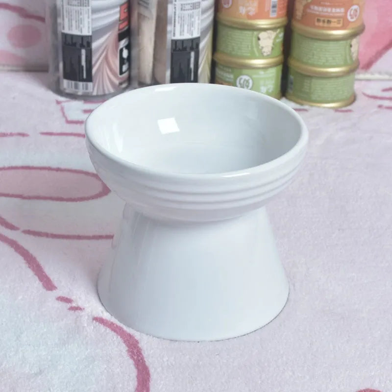 Black ceramic pet bowl with a chin-high foot and raised neck protector on a white background.