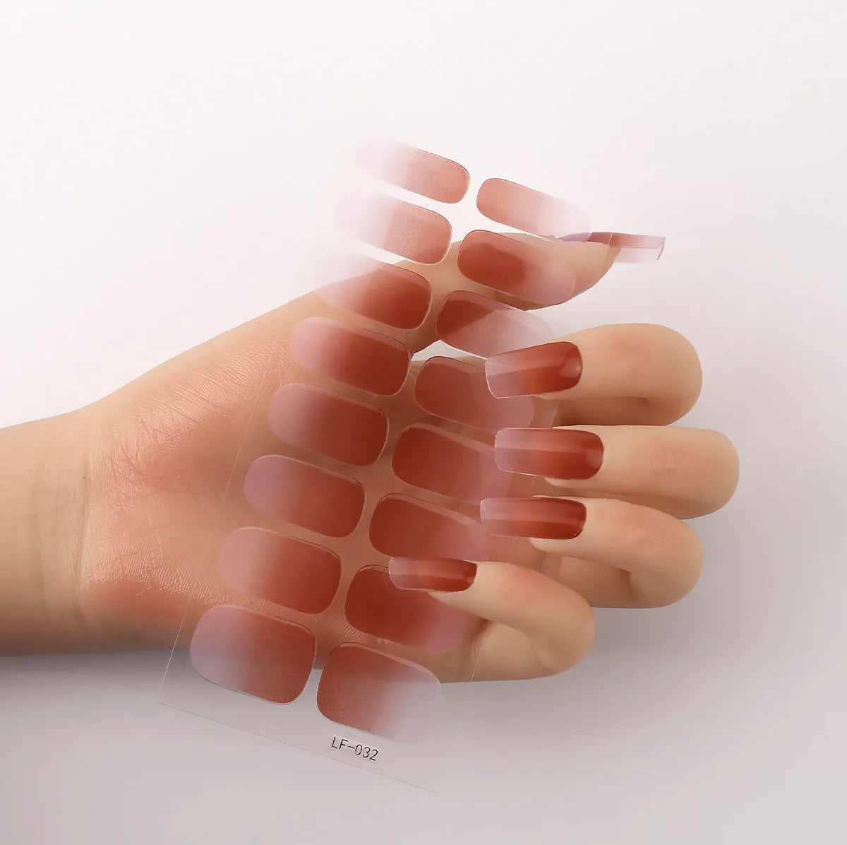 Set of 16 solid colour nail art stickers showing floral, geometric, and pattern designs for manicure application