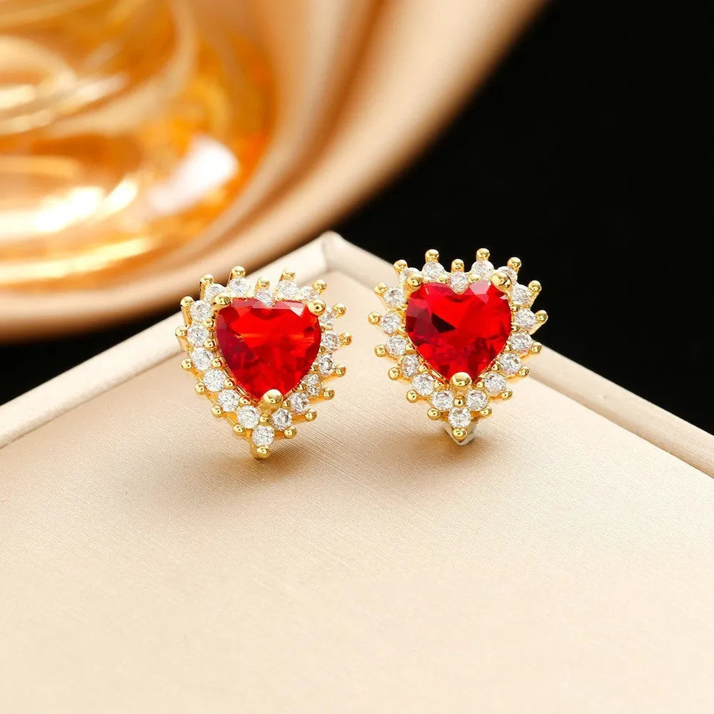 Gold-red titanium steel necklace and earrings set with heart-shaped flower pendant and gemstone detail.