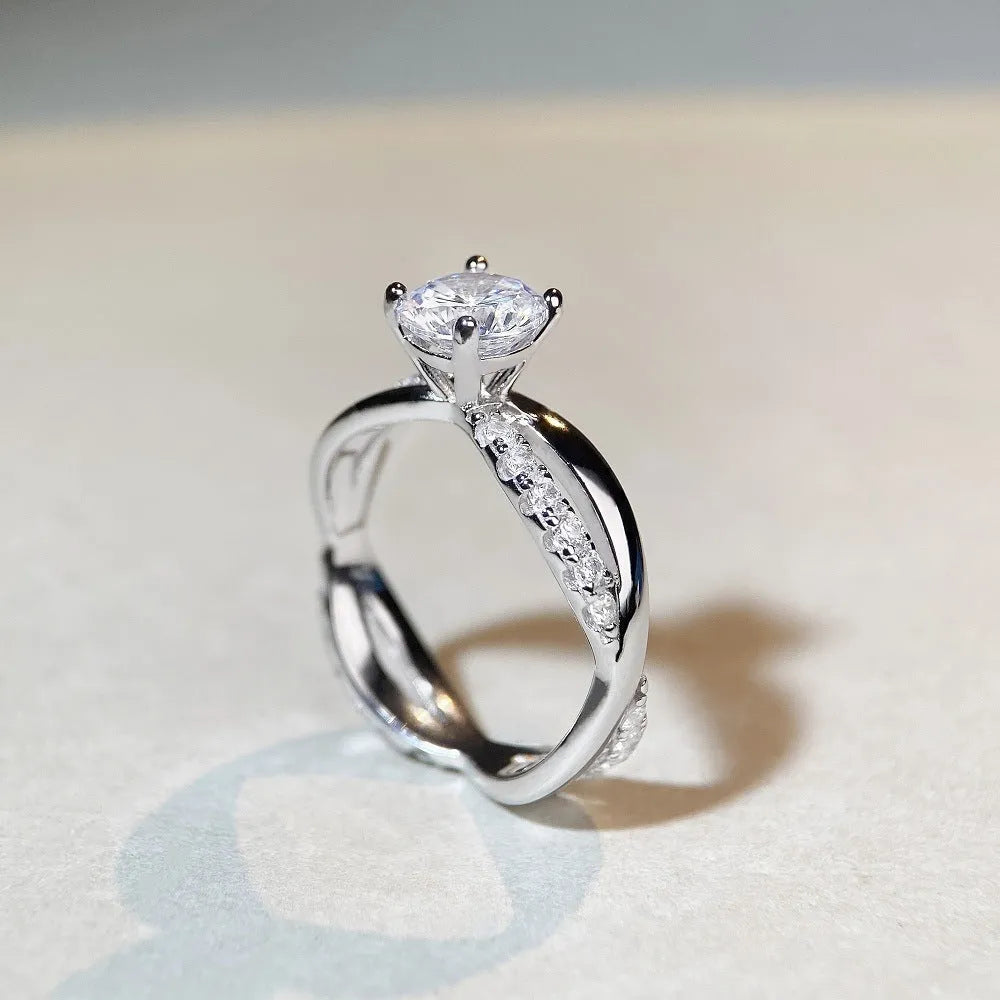 Geometric silver ring with 1 karat moissanite stone in four-claw setting and twisted arm winding band