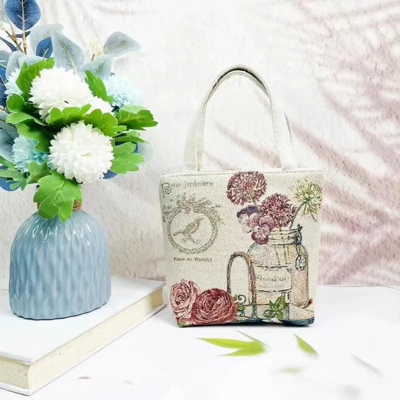 Handheld canvas bag with gold wire embroidery, shown in one of seven colour designs.