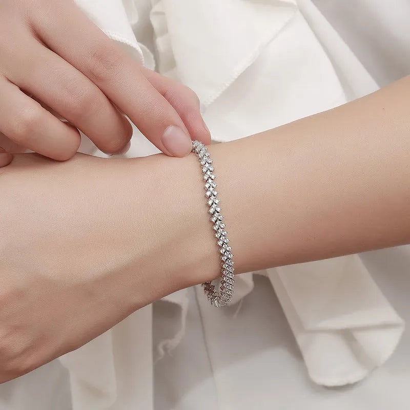 Silver plaid bracelet for women with moissanite stone on neutral background showing woven pattern and clasp