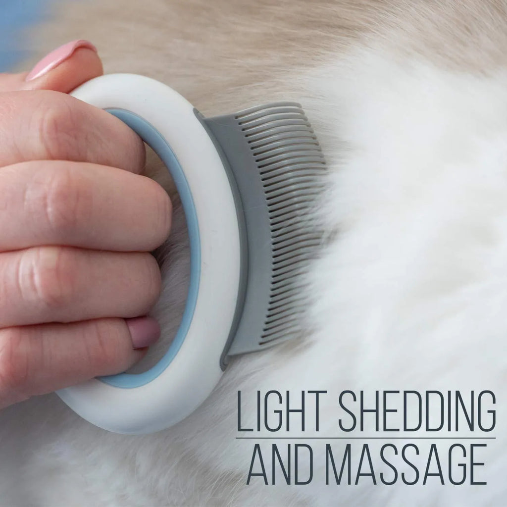 Blue pet grooming comb for cats and dogs on a white background.