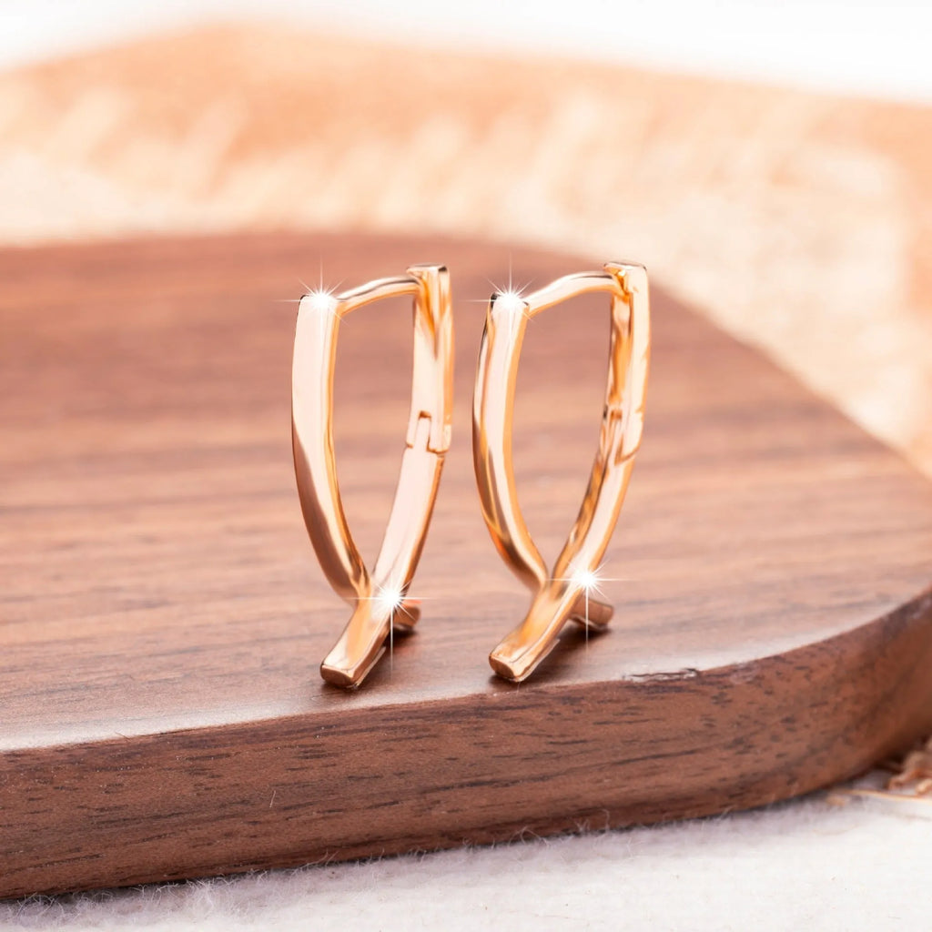 Rose gold cross shaped earrings with polished finish on copper construction