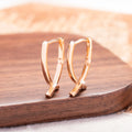 Rose gold cross shaped earrings with polished finish on copper construction