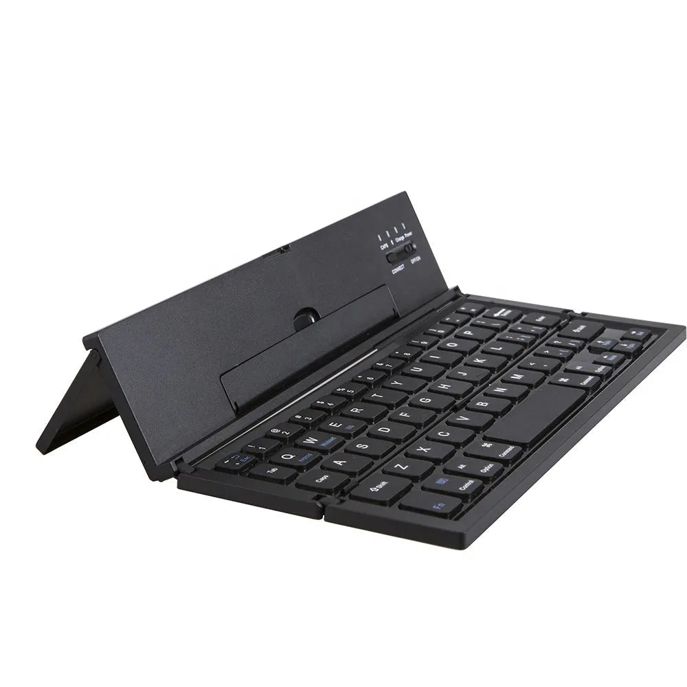 A black mini folding wireless Bluetooth keyboard shown open next to a tablet.