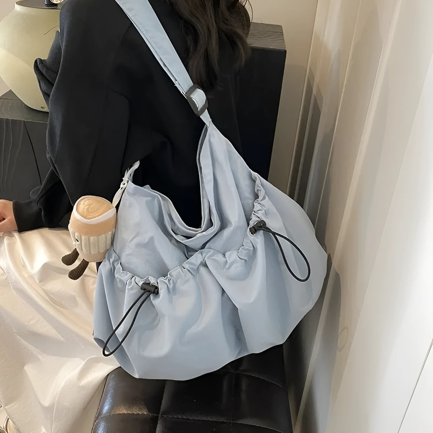Soft green pleated foldable crossbody bag showing split pocket and internal mobile phone compartment