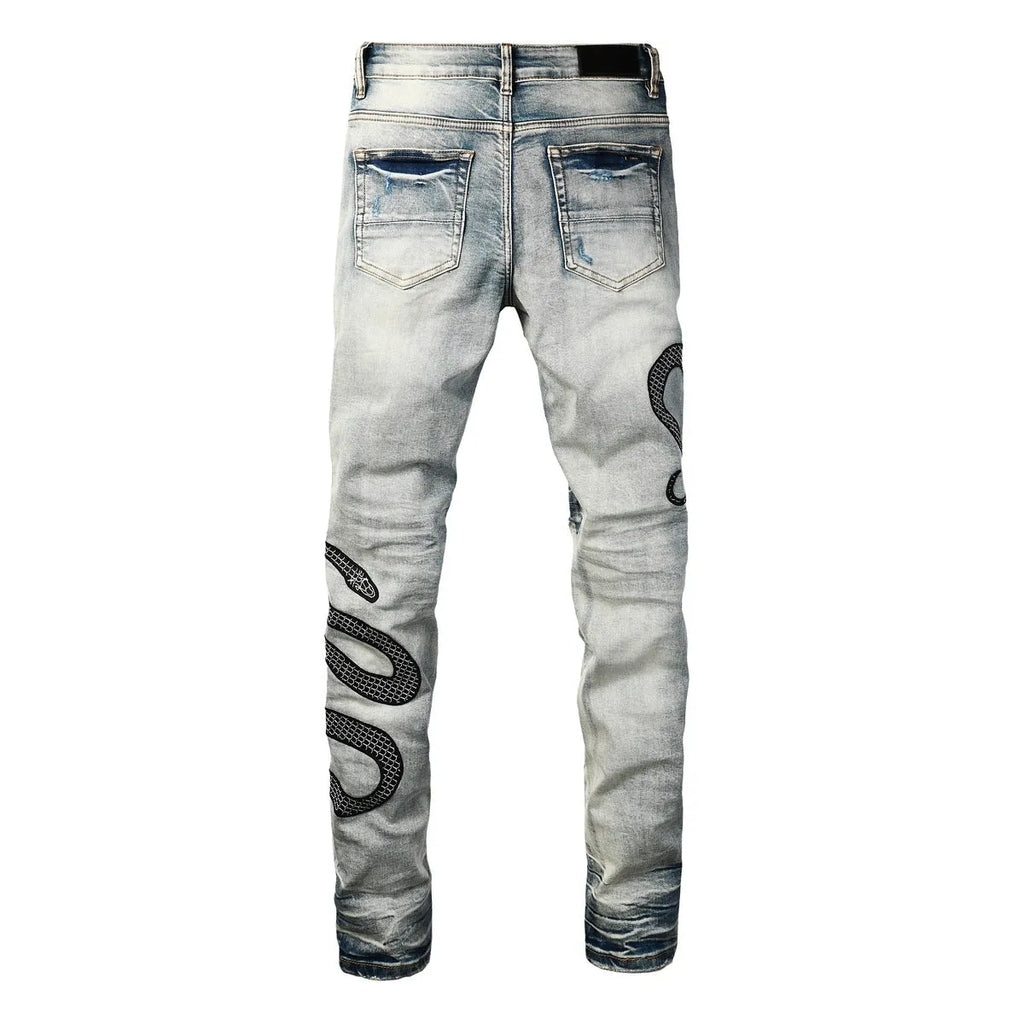 Blue distressed skinny jeans with a mid-waist and button-fly opening on a neutral background.