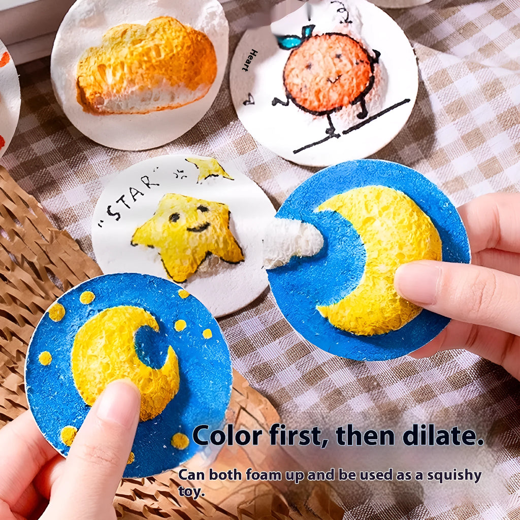 Painting sponge set showing heart, round, and square cellulose sponges with a stack of wood pulp paper for watercolour art.