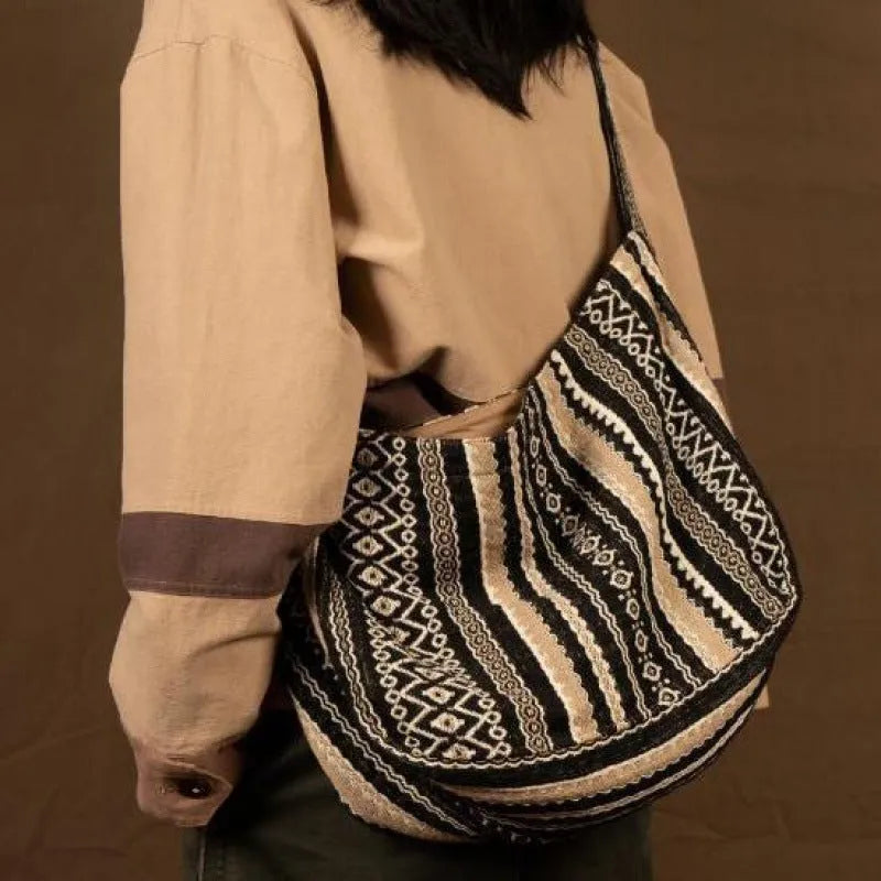 Corduroy vintage messenger bag with jacquard stripes, handprint detail, and an adjustable plaid shoulder strap.