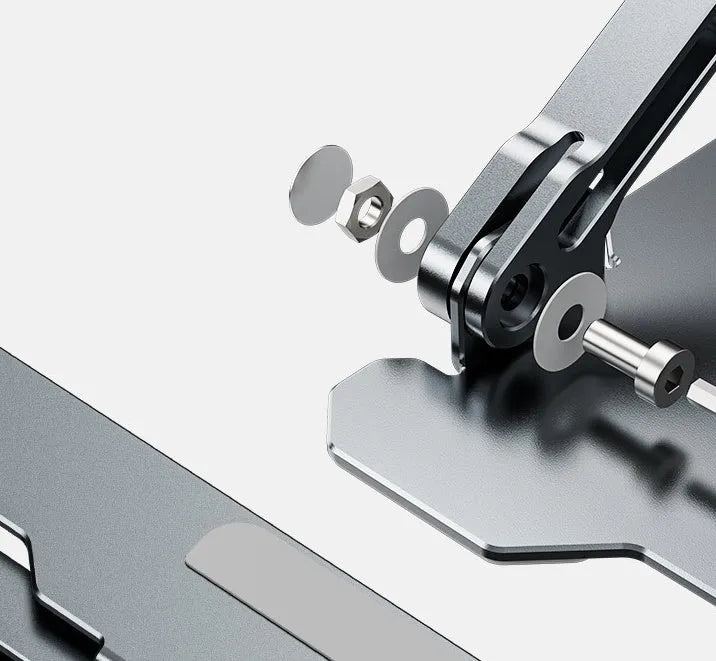 Grey aluminium folding laptop stand holding a silver laptop at an angle on a wooden desk.