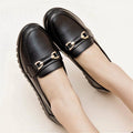 Black women's casual leather pumps with a round toe and soft rubber sole.