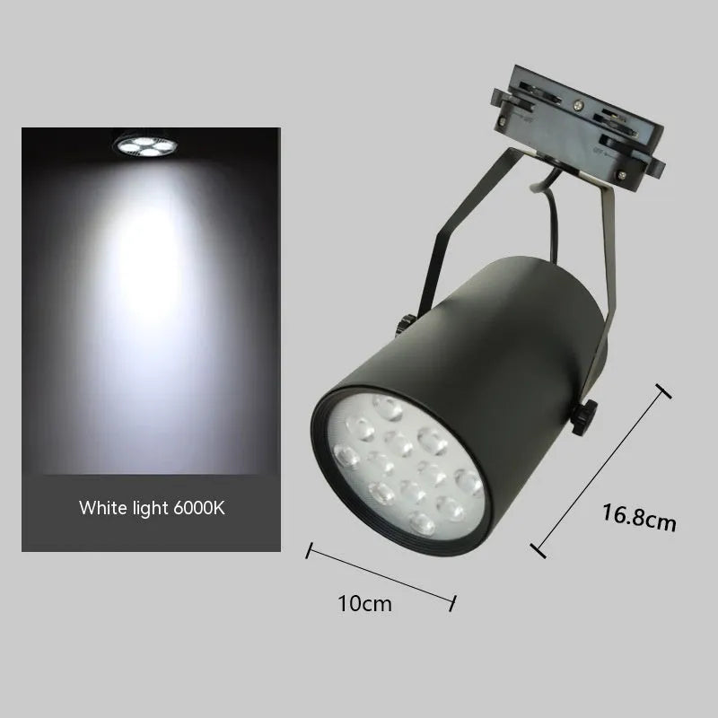 Black aluminium LED track spotlight with sliding head mounted on a track for wall lighting.