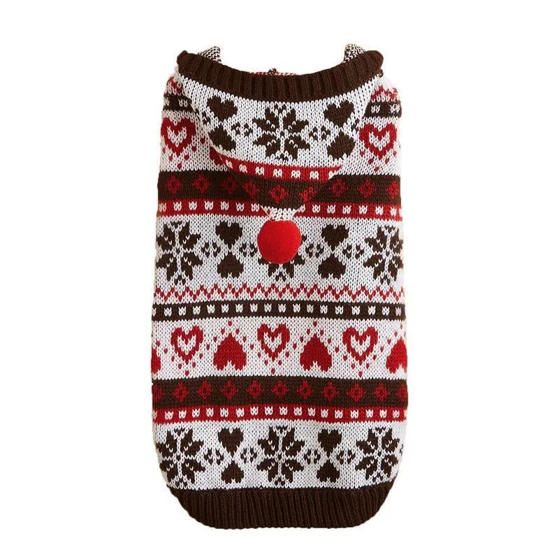 Pink striped dog sweater with snowflake and heart patterns on a small white Bichon