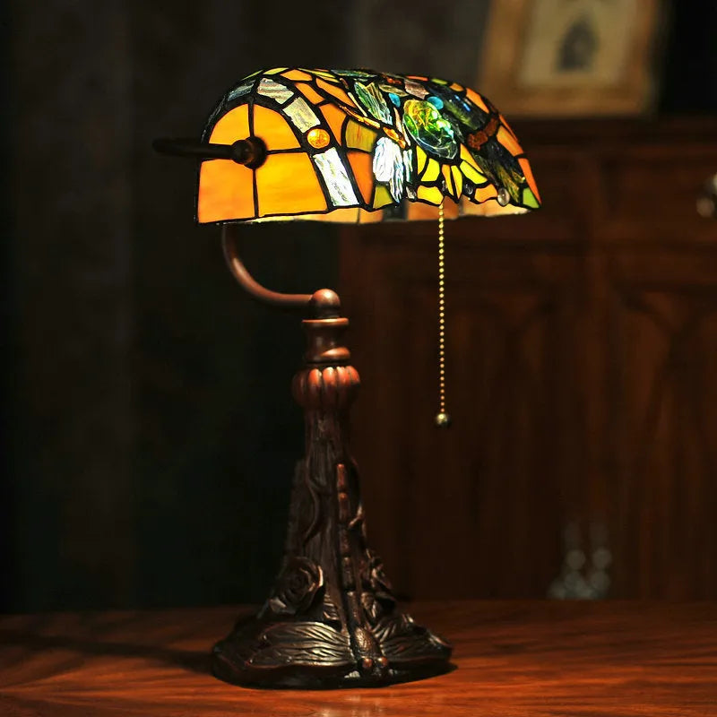 10-inch Tiffany table lamp with coloured stained glass shade and resin base on desk